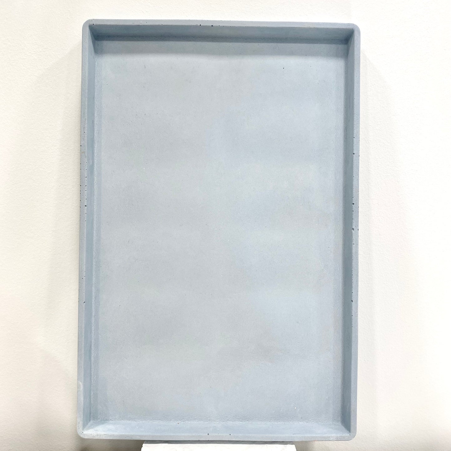 Round and rectangular concrete tray